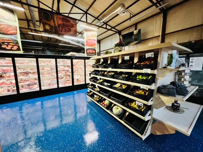 Dunagan Farms Guthrie Store interior showing fresh produce shelves and meat freezers